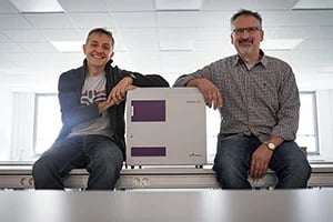 two employees with a PHERAstar FSX two employees with a PHERAstar FSX