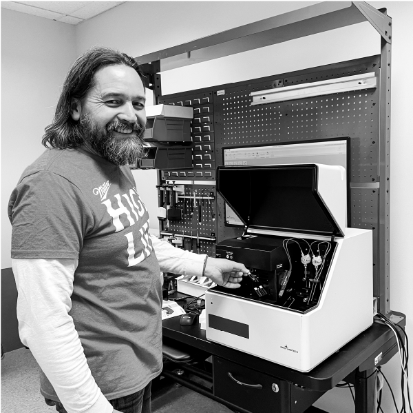 Carl Peters with a microplate reader