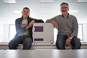 two employees with a PHERAstar FSX two employees with a PHERAstar FSX